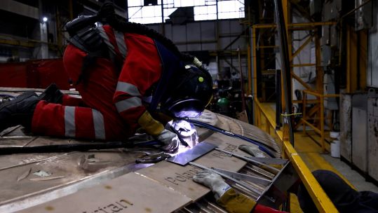 A welder works on the UK-made Unity Shield memorial to those who served in the coalition in the First Gulf War