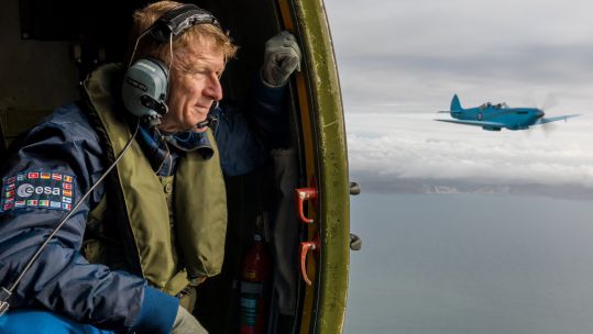 Former Army Air Corps officer and British astronaut Tim Peake looks on from the Battle of Britain Memorial Flight's Dakota