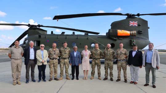 King Abdullah poses with a Chinook used for firefighting duties