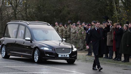 The cortege carrying the body of Lance Corporal George Hooley passes the Memorial Garden in Carterton, West Oxfordshire, following his repatriation into RAF Brize Norton
