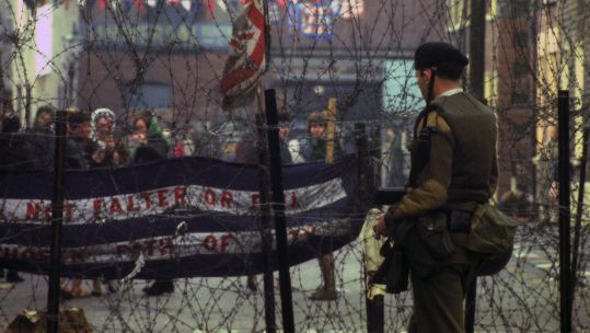 A soldier on duty beside barbed wire barricades on the Falls Road, Belfast in 1969 (Picture: PA Images)