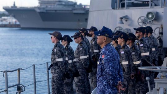 Sailors from the Royal Australian Navy and Japan Maritime Self-Defence Force fall in on the forecastle of HMAS Ballarat