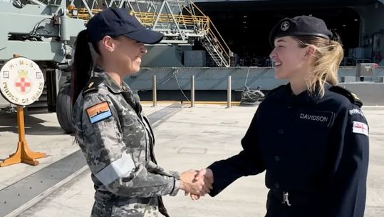The two women meet up by the aircraft carrier in Darwin