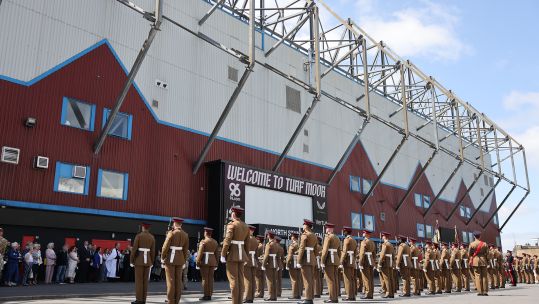 1st Battalion, 1 Lancs, stand to attention in front of Turf Moor, Burnley FC's ground, in the town