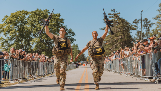 1st Lt Gabrielle White and Capt Seth Deltenre compete in the 'final buddy' run event of the 2025 Best Ranger Competition at Victory Pond, Fort Benning, Georgia