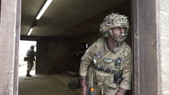 Soldier from the Royal Gibaltar Regiment takes up arcs on a doorway