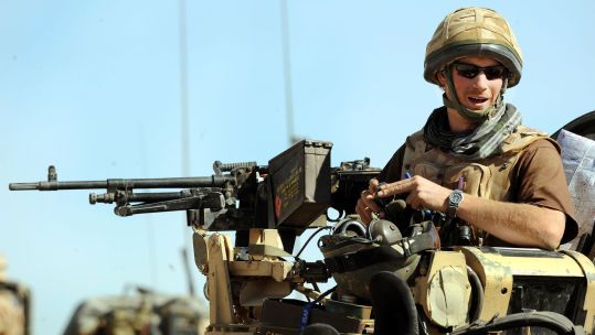 Prince Harry sitting in his position on a Spartan armoured vehicle in Helmand Province, Afghanistan (Picture: PA Images)