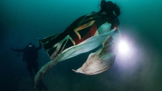 Royal Navy divers carry White Ensign to site of HMS Royal Oak