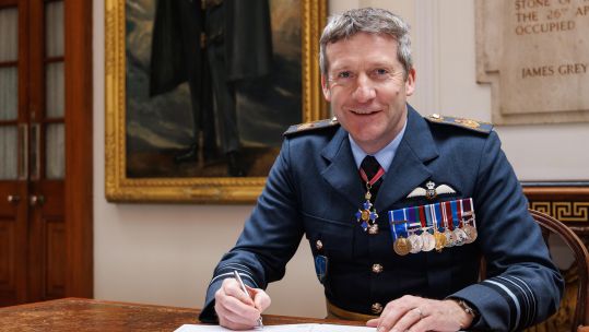Air Chief Marshal Sir John Stringer poses as he signs to become Nato DSACEUR