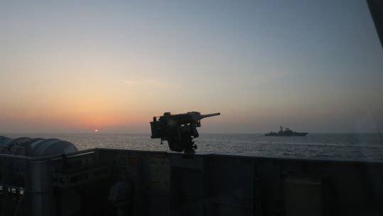 Sun sets over HMS Trent shadowing Russian warship