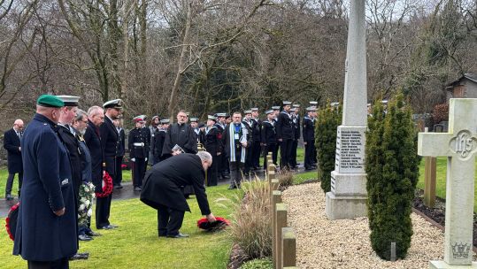 A wreath is laid at the base of the memorial for the victims of the K13 disaster