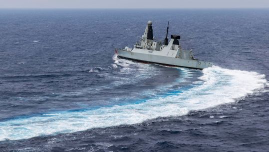 MS Dragon is snapped from a Wildcat Helicopter as the ship conducts high-speed manoeuvres as she continues to carry out air defence operations in the Eastern Mediterranean
