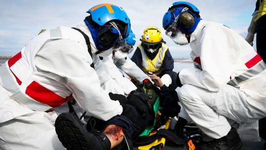 Medical teams treat a simulated casualty during a crash-on-deck exercise on the flight deck of HMS Queen Elizabeth (Picture: MOD)