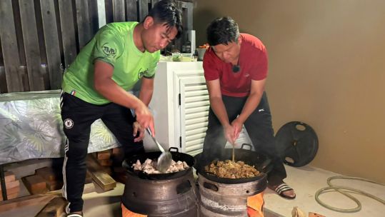 Two pots of Gurkha curry are prepared for the hungry guests