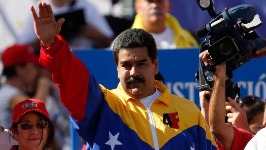Venezuela's President Nicolas Maduro waves to supporters during a rally to reject the sanctions that the US government seeks to impose on officials accused of human rights violations, in Caracas December 15, 2014.