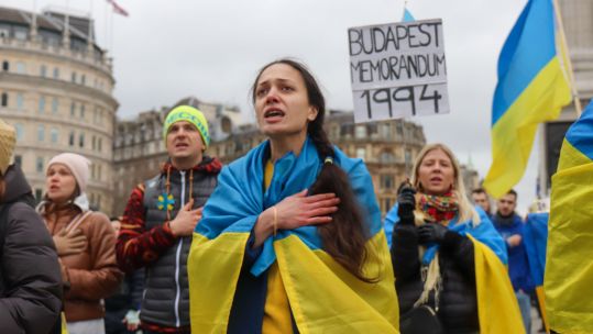  Protesters sing the Ukrainian national anthem during a protest against Russia's invasion of Ukraine on Trafalgar Square. (Picture: Lucy North/Alamy Live News)