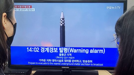  People watch the news on the lifting of an air raid alarm as of 2 p.m. at an office in Seoul after North Korea fired around 10 missiles 
