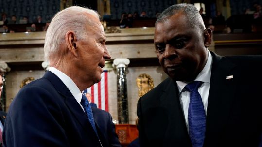 President Joe Biden talks with Defense Secretary Lloyd Austin after the State of the Union address to a joint session of Congress at the Capitol