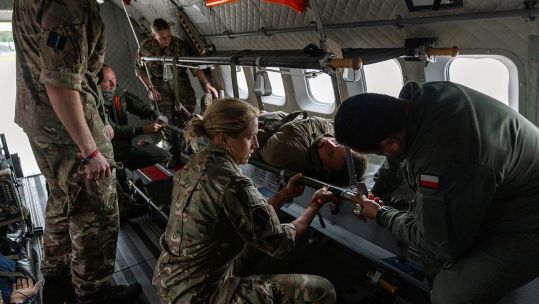 The RAF's Medical Team and Polish medics load a casualty onto an aircraft during an aero casualty evacuation (casevac) on Exercise Vigorous Warrior (Picture: MOD)