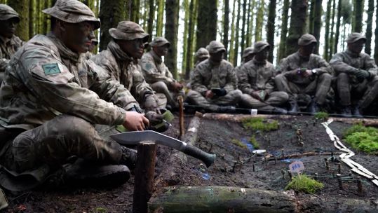 Gurkha recruits at ITC Catterick build a model of the ground during a fieldcraft exercise