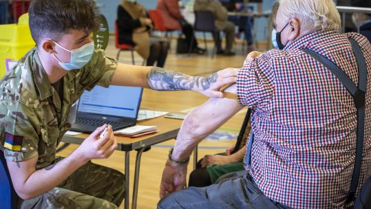 Cover image: Military personnel vaccinating at a centre in Cwmbran, South Wales (Picture: MOD).