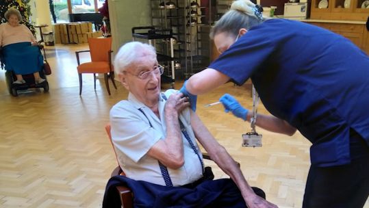 95-year-old Navy veteran Harry Southern receiving his COVID vaccine