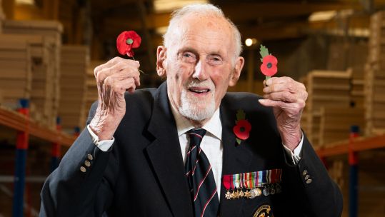 99-year-old D-Day veteran John Roberts holds new plastic-free poppy