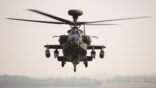 An AH-64E flies over Salisbury Plain