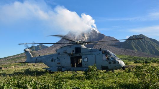 A Merlin Mk4 of 845 NAS lands in Monstserrat's exclusion zone with the smoking Soufrière Hills volcano in the background 271020 CREDIT ROYAL NAVY.jpg