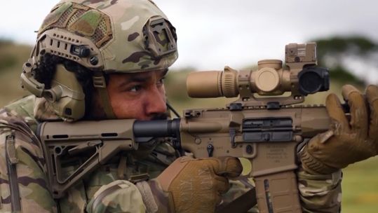 A Royal Marine operating the match grade two stage trigger on the KS-1 rifle on the range in Scotland.