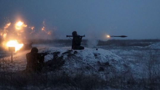 A Russian soldier fires a rocket-propelled grenade launcher during drills near the Ukraine border