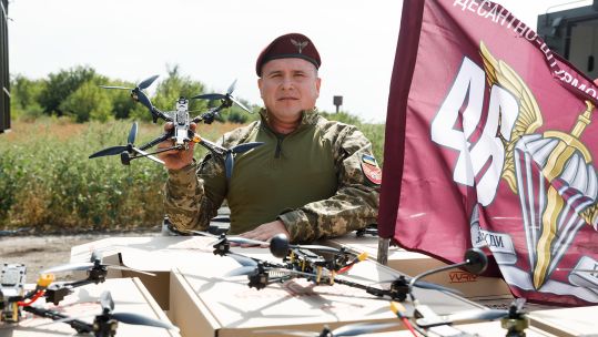 A Ukrainian serviceman from the Airborne Assault Brigade is seen demonstrating a drone