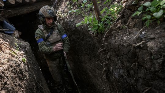 A Ukrainian soldier loading a warhead into a rocket propelled grenade launcher in a defensive position near Vuhledar (Picture: Alamy)