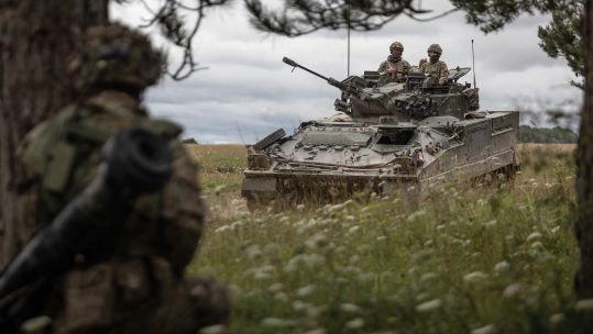 A Warrior vehicle moves across the training area., Exercise IRON CYCLONE 25072023 CREDIT MOD.jpg