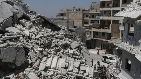 Cover Image: A building reduced to rubble in Idlib following an attack (Picture: PA).