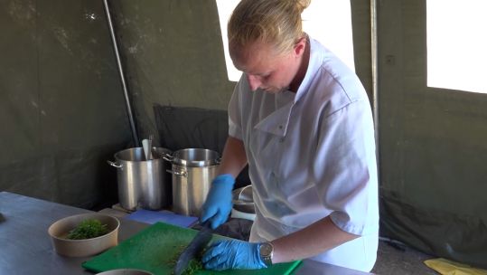 A chef cooks in a field hospital at RAF Akrotiri.