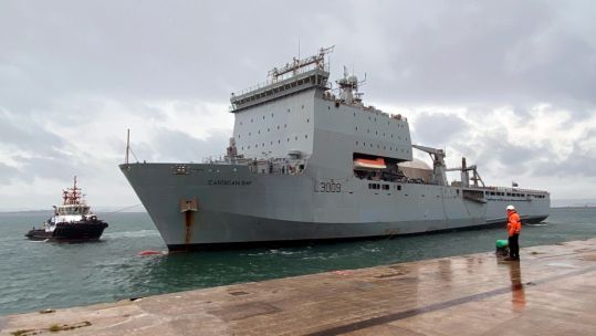 A dockyard worker at Portland waits for RFA Cardigan Bay to berth
