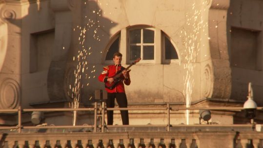 A guitarist plays from up high as part of the Household Division Beating Retreat.