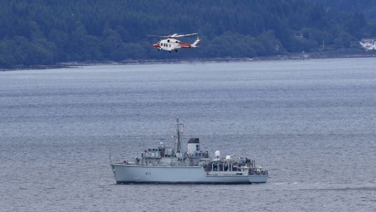 A helicopter is seen above HMS Hurworth as she prepares for NATO minehunting (Picture: Royal Navy).