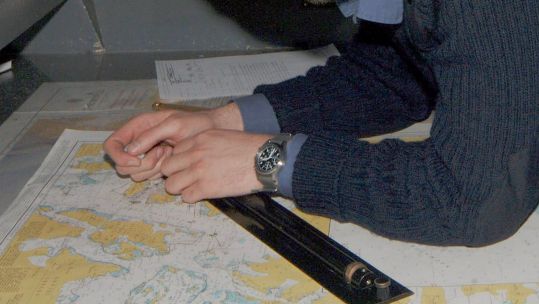 A member of the Royal Navy pictured with a paper chart DATE UNKNONW CREDIT MOD.jpg 