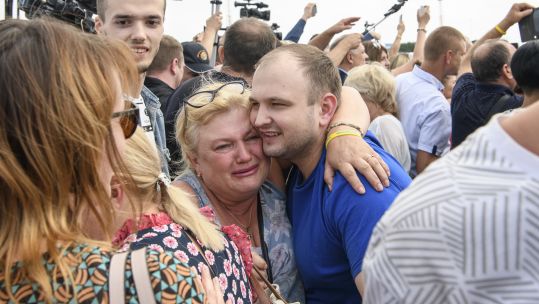 A Ukrainian prisoner is embraced as he arrives in Kyiv after a prisoner swap with Russia (Picture: PA).
