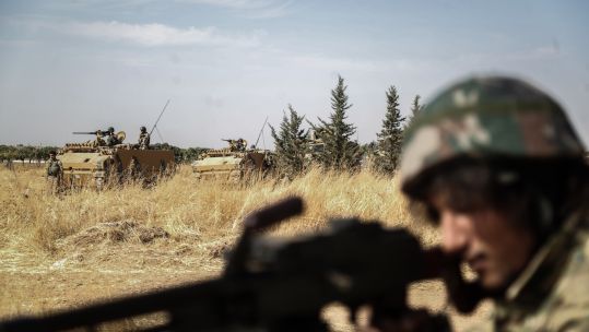 Turkish forces and members of the Turkish-backed Syrian National Army near the border town of Mabrouka (Picture: PA).