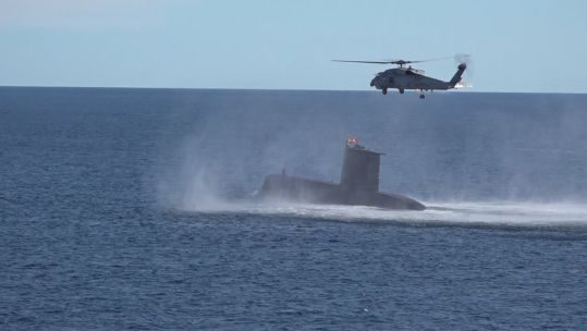 A submarine and Turkish helicopter taking part in Nato's Exercise Steadfast Defender