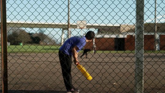 An Afghan child playing cricket at a UK military base after arriving via a resettlement scheme