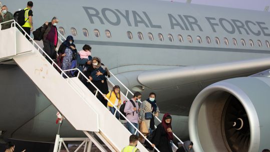 Afghan people departing an RAF flight