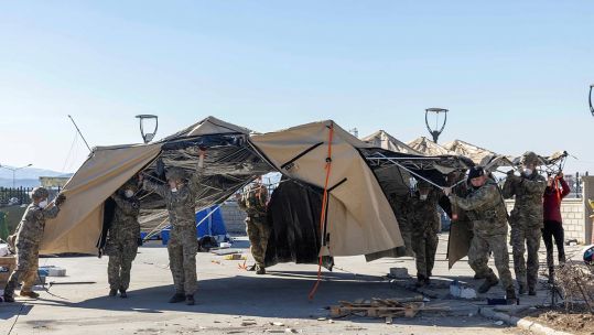 Airborne medics support the EMT team by moving vital equipment away from the hospital in Turkoglu. 