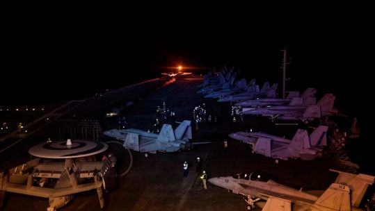 USS Dwight D. Eisenhower launches F/A-18 Hornets fighter jets into the night sky in impressive footage (Picture: US Navy photo by Specialist 3rd Class Nathan T. Beard).