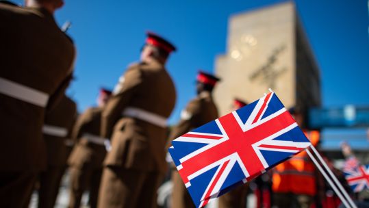 Anonymous - Spectator waving a Union Jack at the farewell of the British soldiers in Gutersloh 
