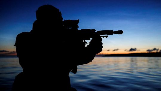 Anonymous Royal Marine from 4 Assault Squadron securing the beach to conduct a recce of the area (Picture: MOD).
