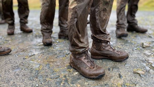Anonymous Royal Marines with mud and grass on their uniform and boots during the 30-miler test